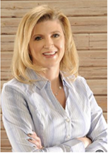 Smiling woman with blonde hair in a light blue shirt.