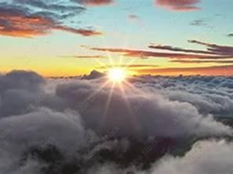 Sunrise above the clouds with colorful sky hues.